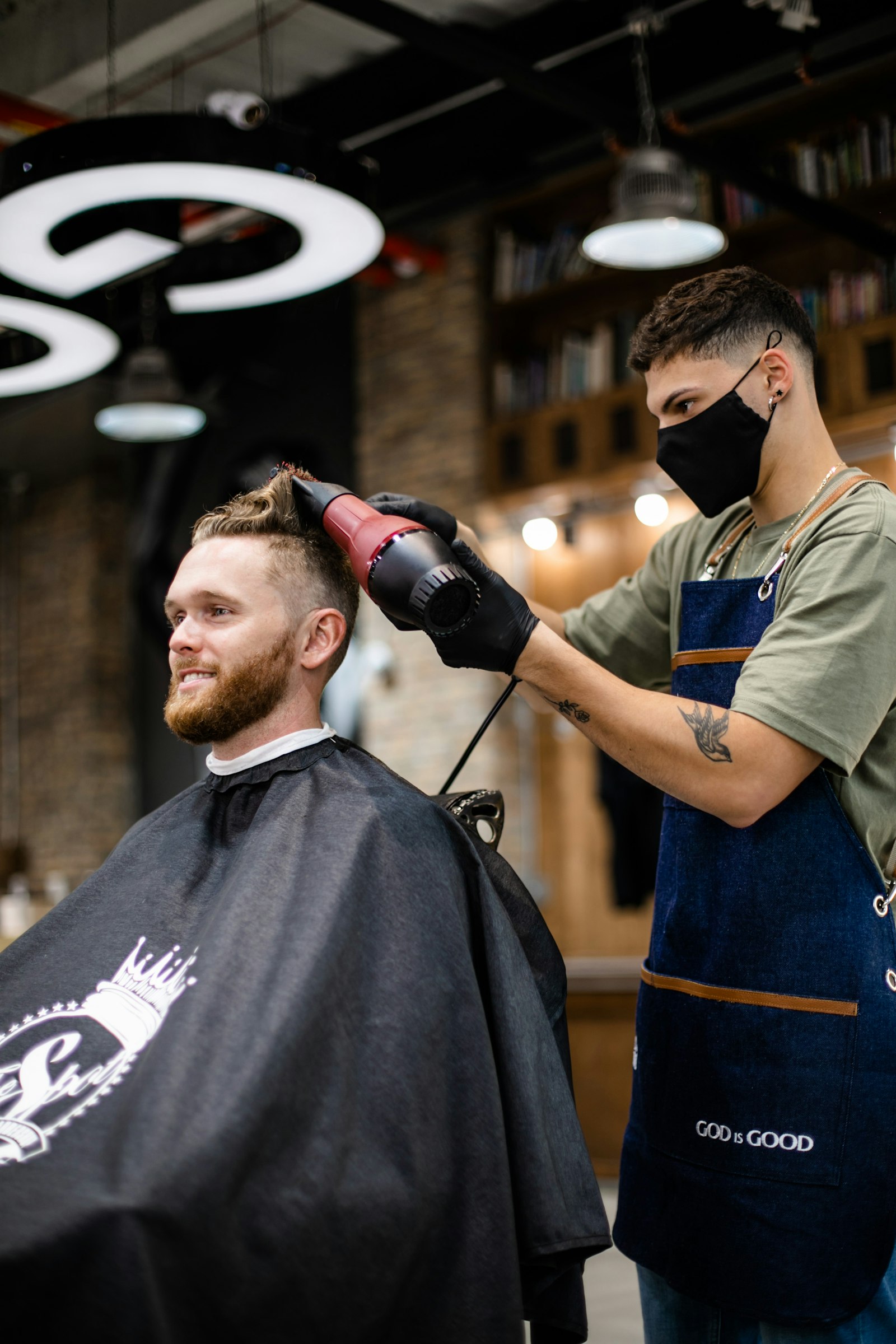 Barber creating modern textured fade with clipper blending technique